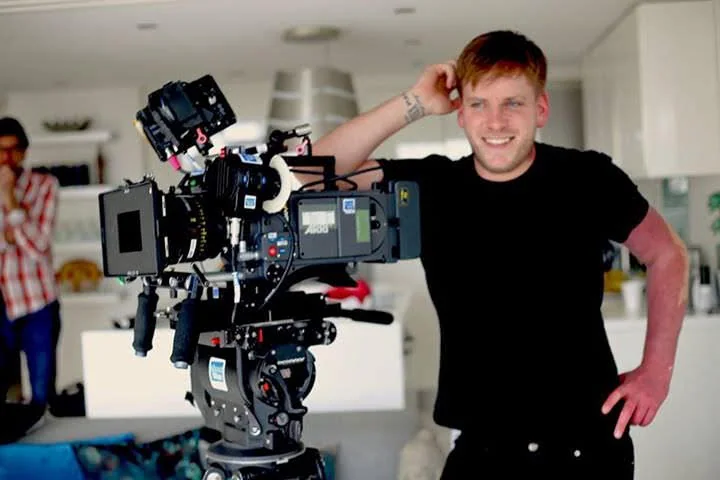 Dean Woodford beside a film camera
